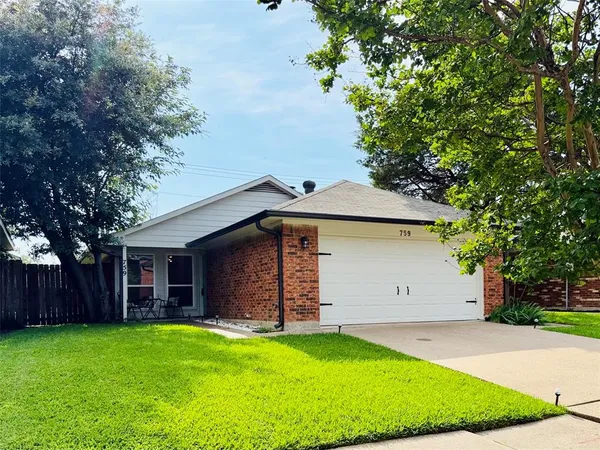 a front view of house with a garden
