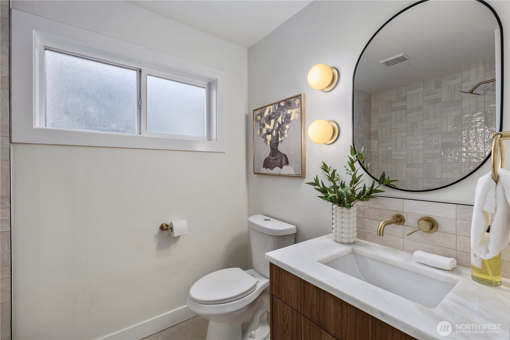 1005 North 33rd Street Renton, WA 98056 - Photo 22 of 36 a bathroom with a sink vanity mirror and toilet