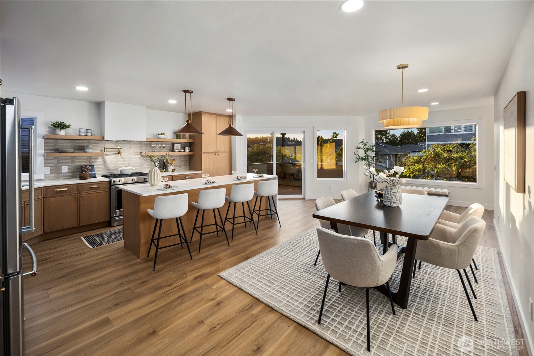 1005 North 33rd Street Renton, WA 98056 - Photo 6 of 36 a dining room with stainless steel appliances kitchen island granite countertop a sink a stove a dining table and chairs