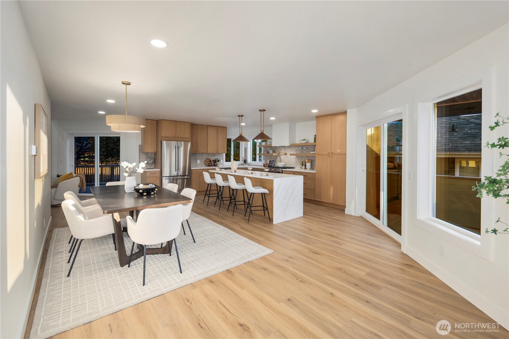 1005 North 33rd Street Renton, WA 98056 - Photo 7 of 36 a living room with stainless steel appliances kitchen island granite countertop furniture and a wooden floor