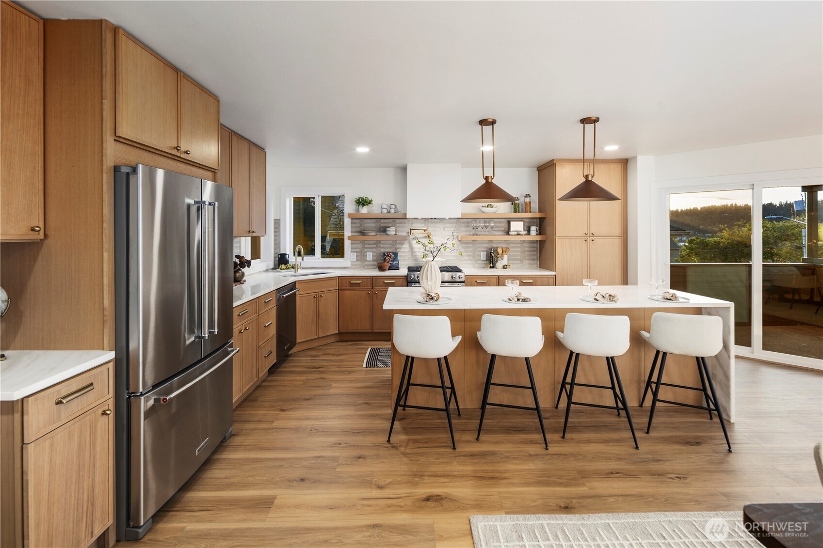 1005 North 33rd Street Renton, WA 98056 - Photo 8 of 36 a kitchen with kitchen island stainless steel appliances a table chairs sink and cabinets