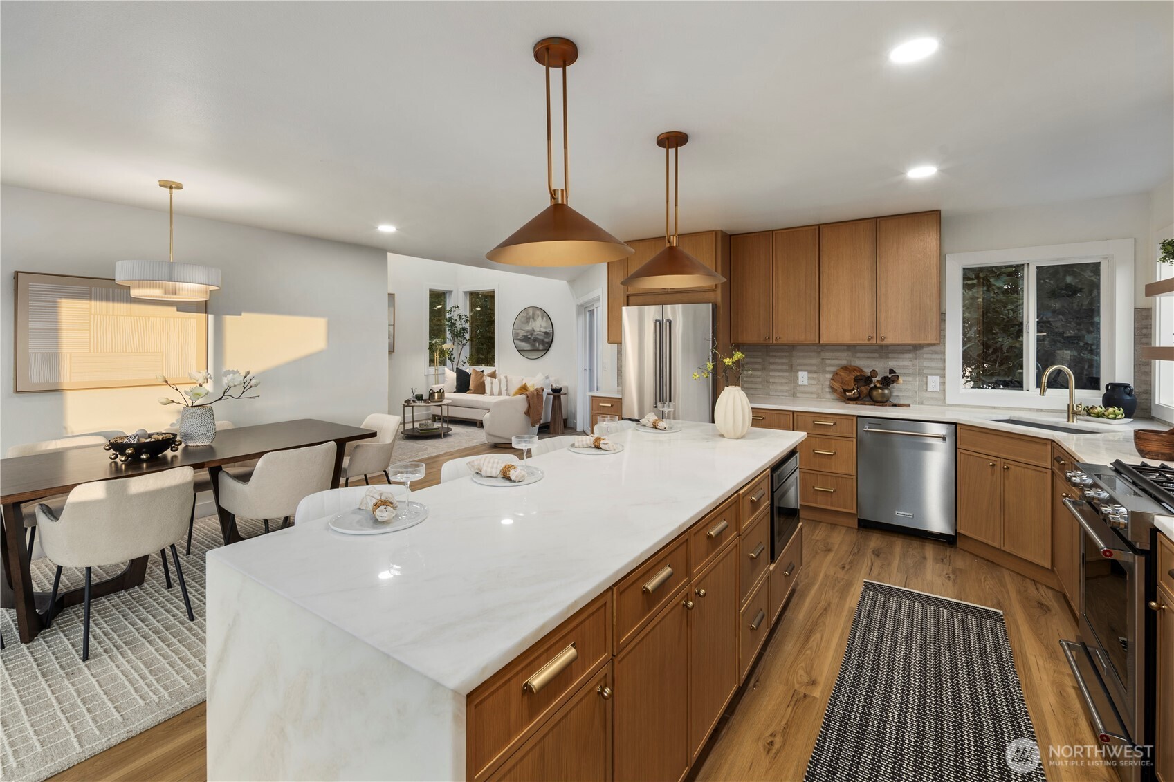 1005 North 33rd Street Renton, WA 98056 - Photo 9 of 36 a large kitchen with kitchen island a large counter space a sink stainless steel appliances and cabinets