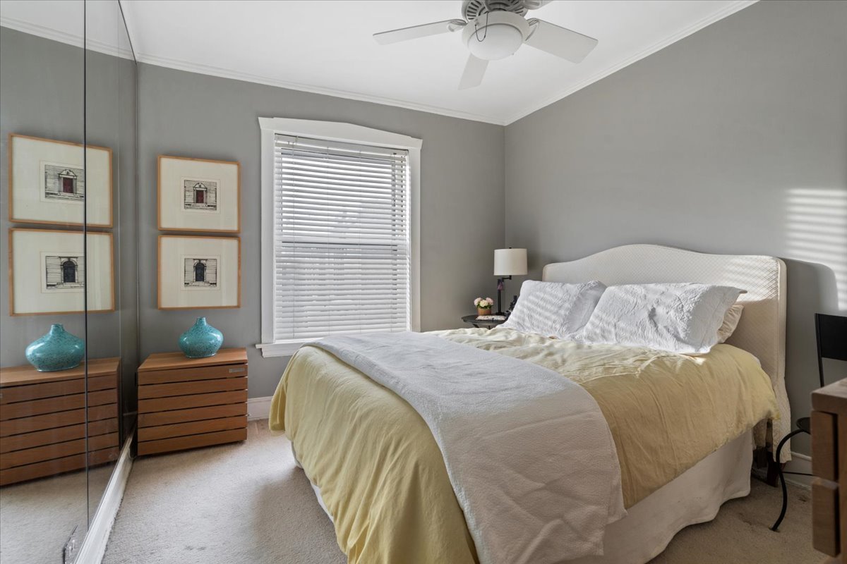 594 Sheridan Square, Unit 3 Evanston, IL 60202 - Photo 11 of 14 a bedroom with a bed and a chandelier