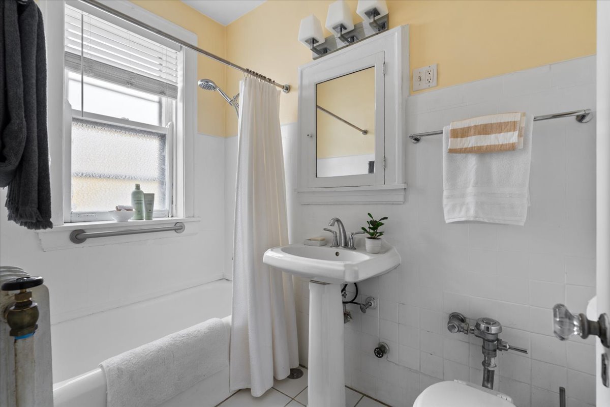 594 Sheridan Square, Unit 3 Evanston, IL 60202 - Photo 12 of 14 a bathroom with a sink a toilet and shower
