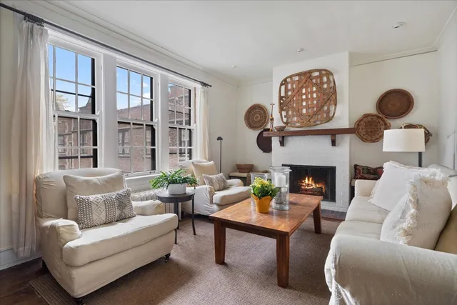 a living room with furniture a rug and a fireplace