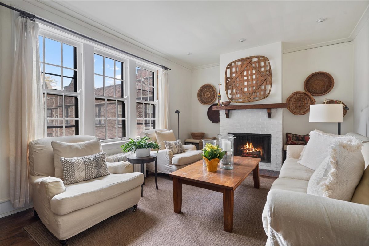 594 Sheridan Square, Unit 3 Evanston, IL 60202 - Photo 3 of 14 a living room with furniture a rug and a fireplace