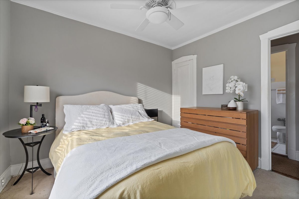 594 Sheridan Square, Unit 3 Evanston, IL 60202 - Photo 10 of 14 a bedroom with a bed and a chandelier