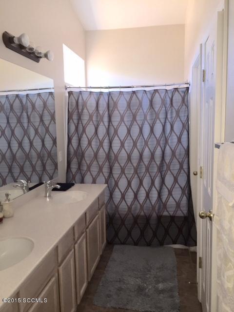 1770 Guess Court Rio Rico, AZ 85648 - Photo 9 of 13 a bathroom with a sink and a granite countertop