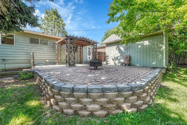 a view of backyard with outdoor seating and plants