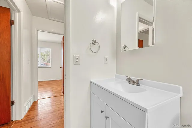 a bathroom with a sink vanity and mirror