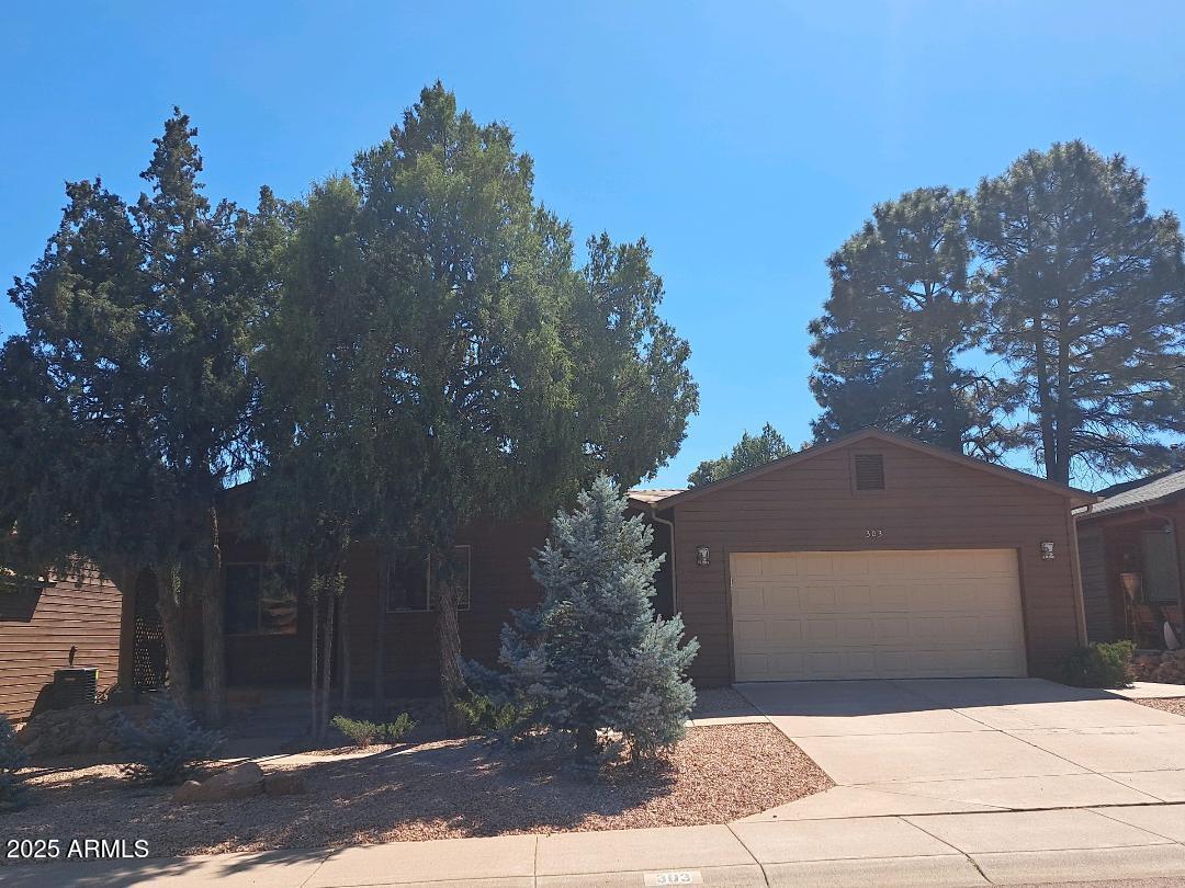 303 West Christopher Point Payson, AZ 85541 - Photo 1 of 27 a front view of a house with trees around
