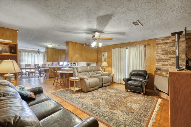 a bedroom with a bed and a flat tv screen on dresser