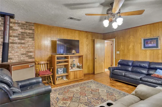 a bathroom with a granite countertop sink a mirror and shower