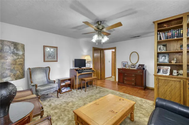 a bedroom with a bed gym equipment and a large window