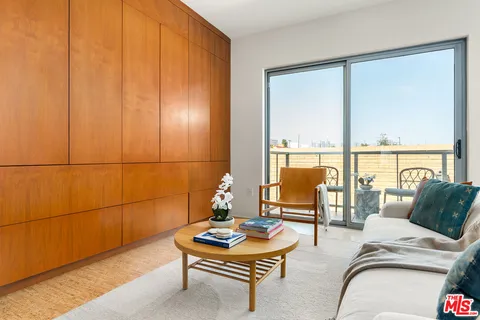 a living room with furniture and a floor to ceiling window