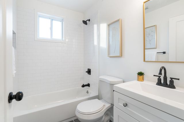 a bathroom with a sink a toilet and a bathtub