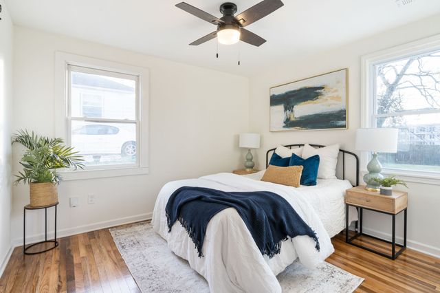 a bedroom with a bed and a potted plant