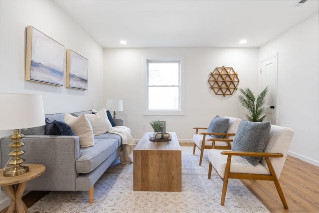 a living room with furniture and a window