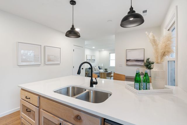 a kitchen with a sink and a mirror
