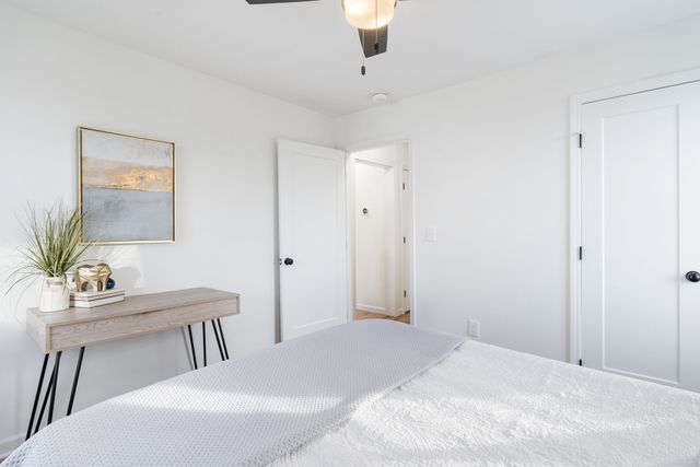 a bedroom with a table chairs and a bed