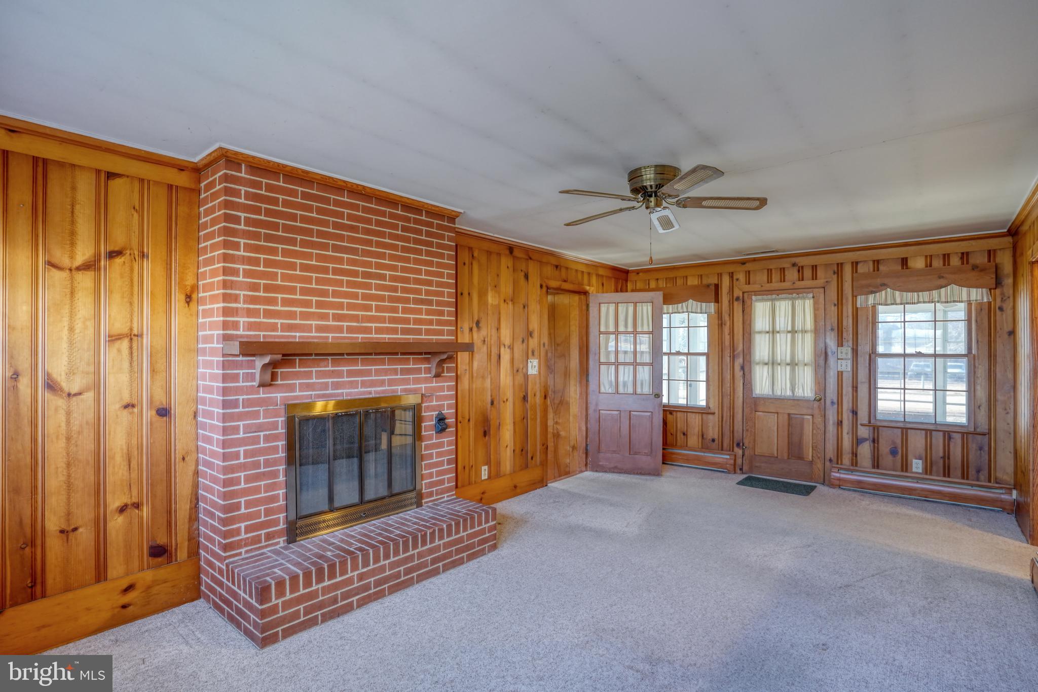 4215 Preston Road Hurlock, MD 21643 - Photo 14 of 40 a living room with furniture and a fireplace