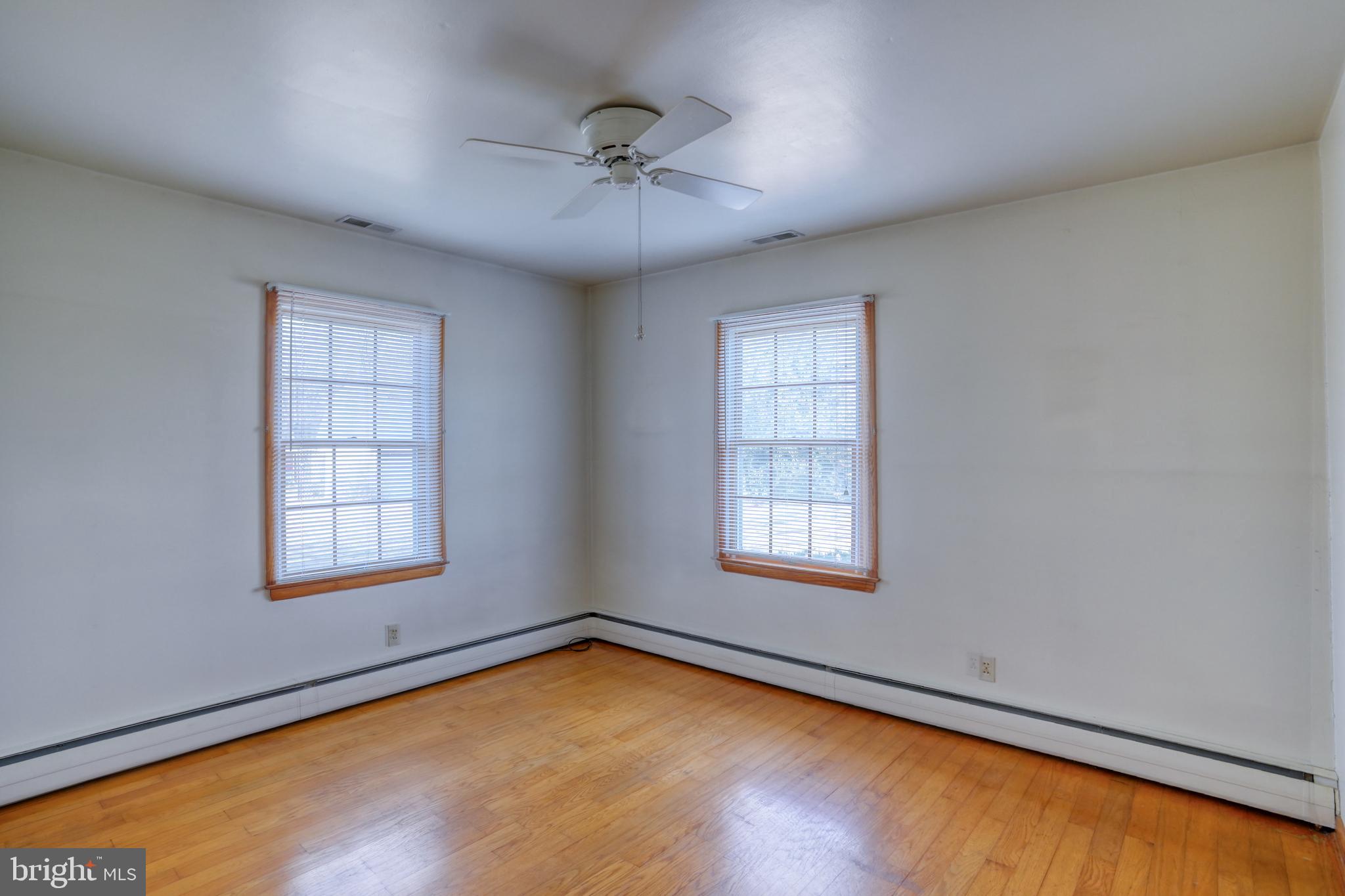 4215 Preston Road Hurlock, MD 21643 - Photo 19 of 40 an empty room with a window and ceiling fan