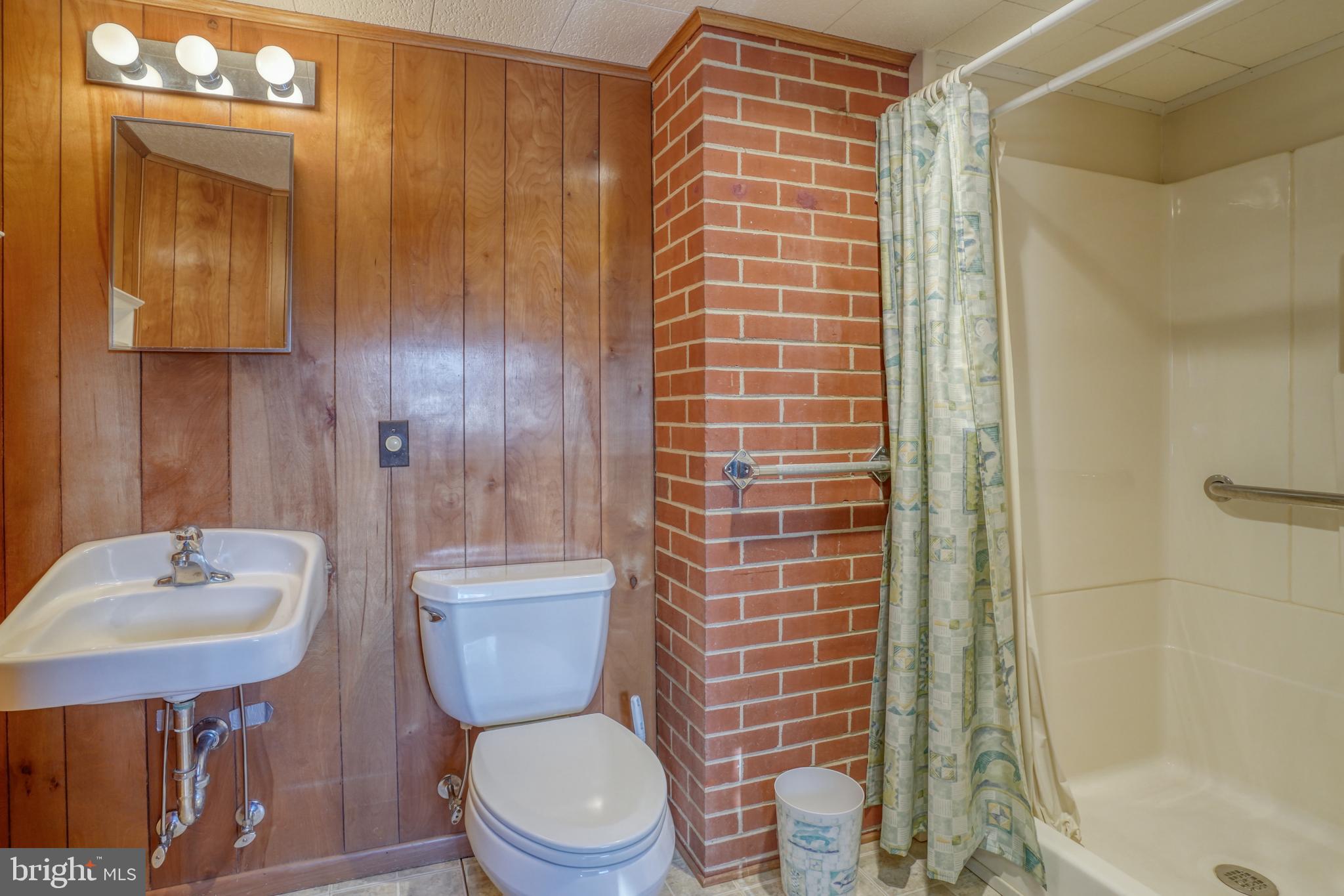 4215 Preston Road Hurlock, MD 21643 - Photo 27 of 40 a bathroom with a toilet a sink and shower