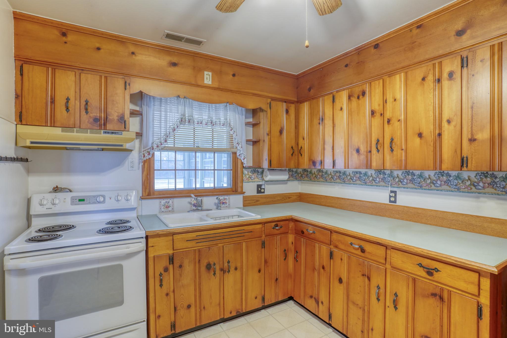 4215 Preston Road Hurlock, MD 21643 - Photo 7 of 40 a kitchen with stainless steel appliances granite countertop a sink and cabinets with wooden floor