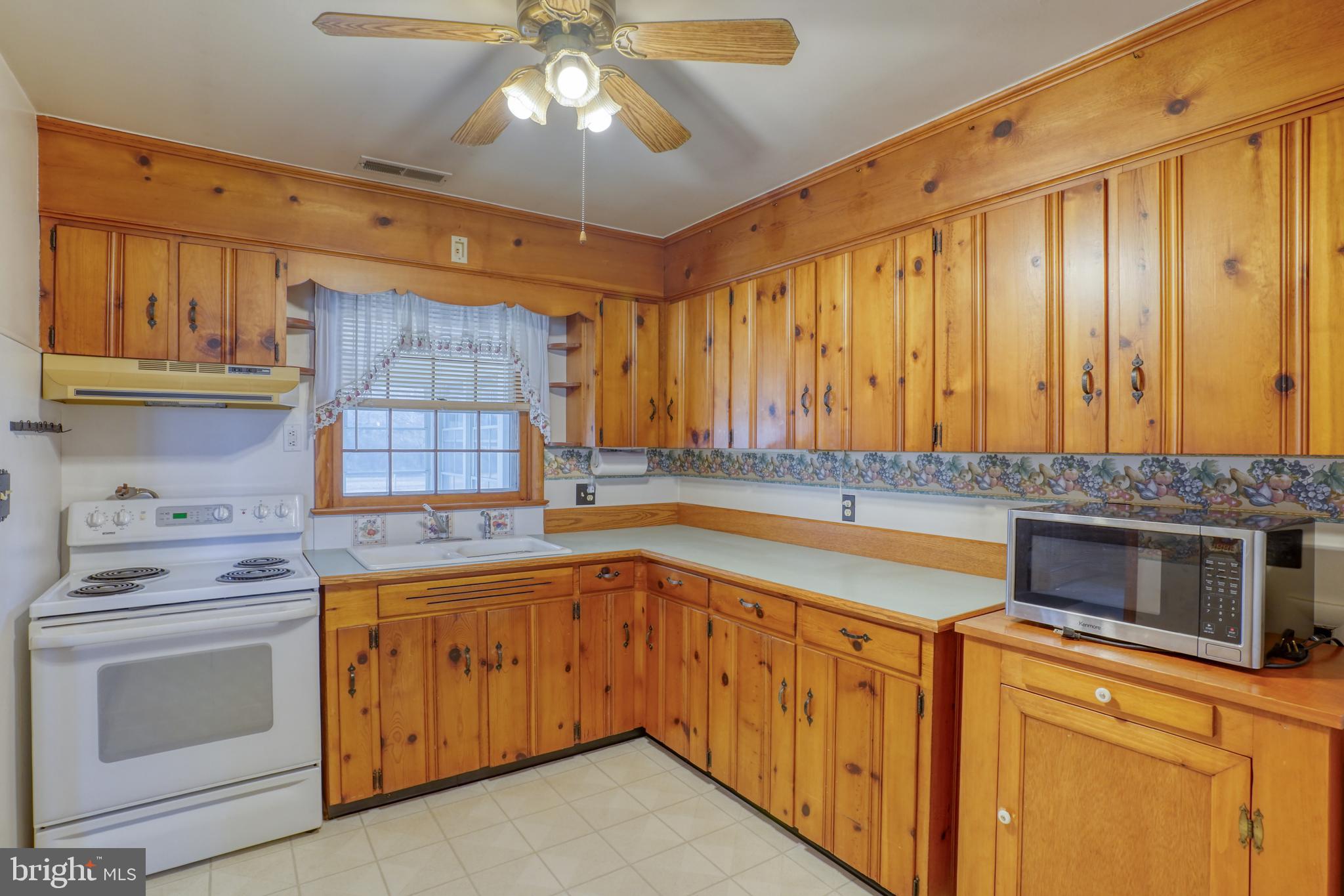4215 Preston Road Hurlock, MD 21643 - Photo 8 of 40 a kitchen with a stove top oven sink and cabinets