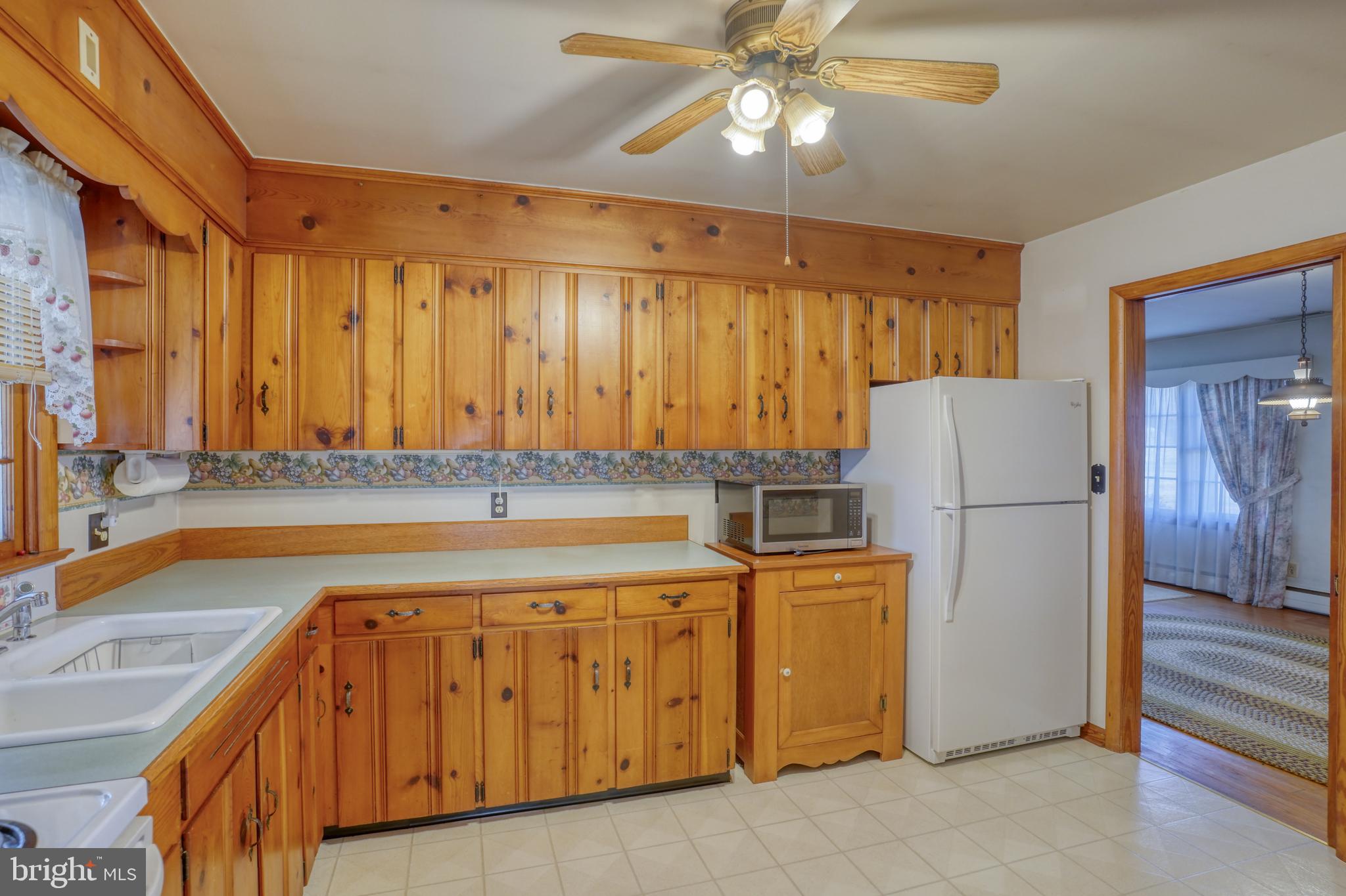 4215 Preston Road Hurlock, MD 21643 - Photo 9 of 40 a kitchen with a refrigerator and a sink