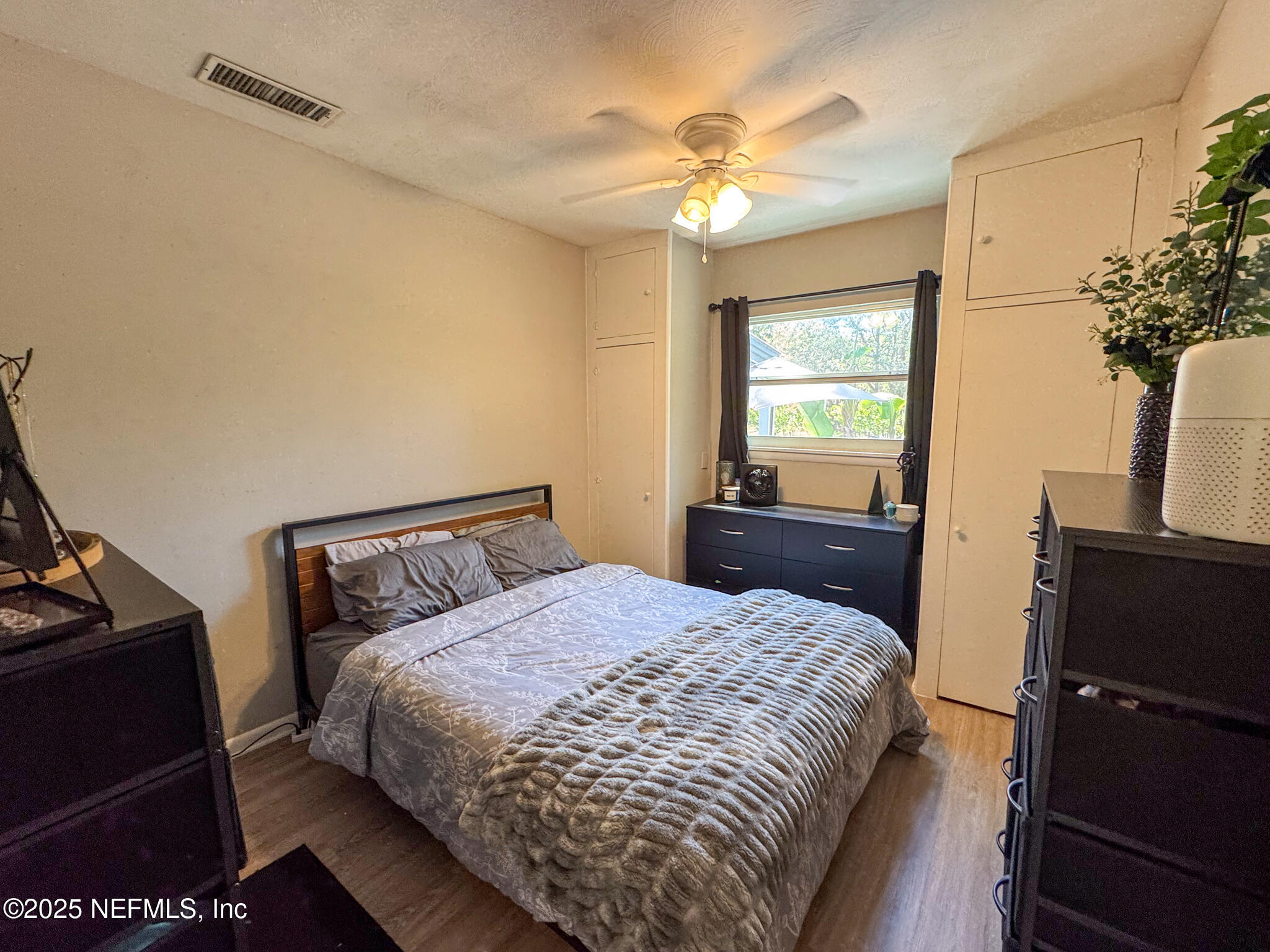 109 Mason Road Melrose, FL 32666 - Photo 13 of 27 a bedroom with a bed and wooden floor