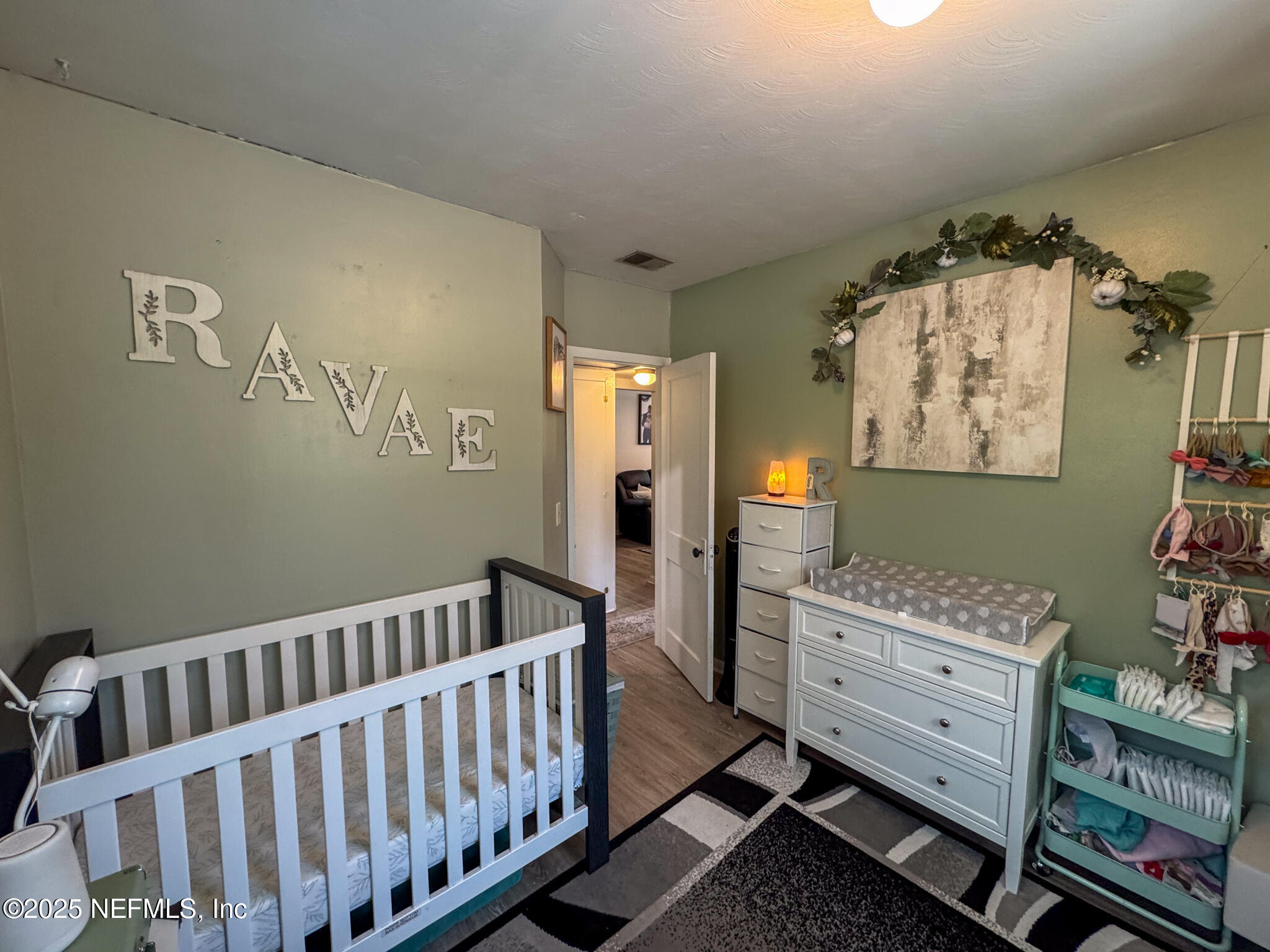 109 Mason Road Melrose, FL 32666 - Photo 17 of 27 a bedroom with furniture and a baby crib