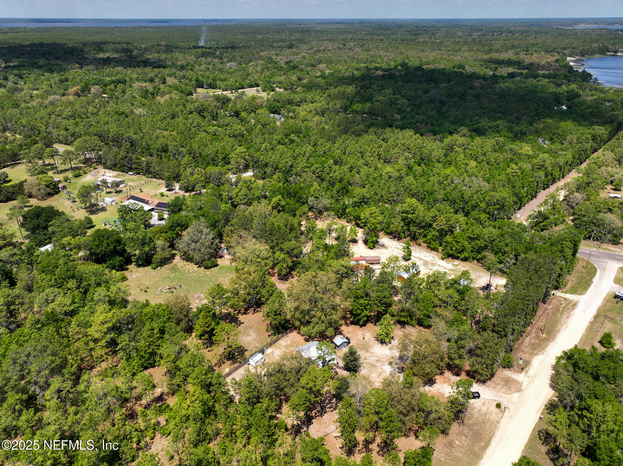 109 Mason Road Melrose, FL 32666 - Photo 26 of 27 a view of a lake with a lush green field