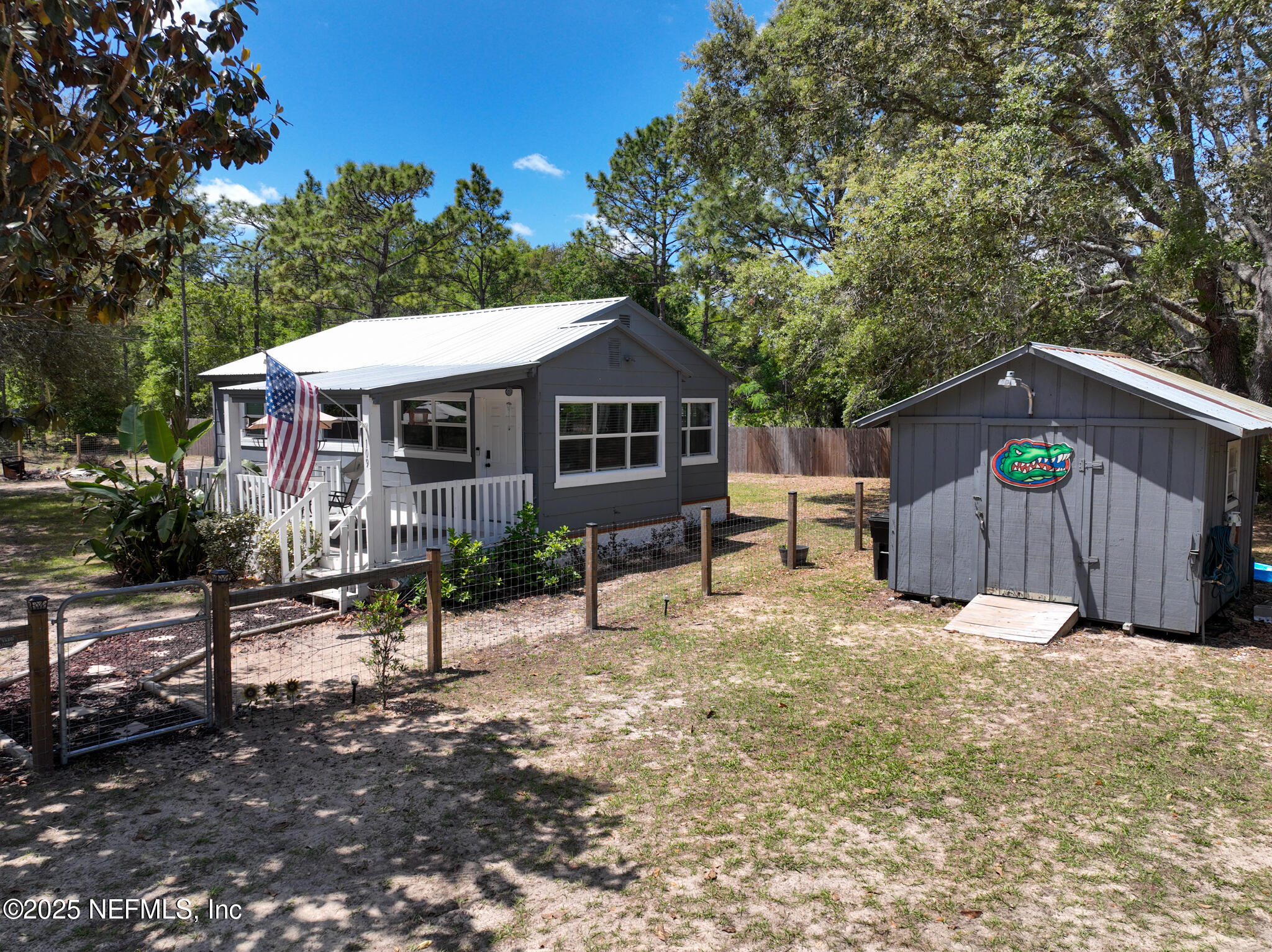 109 Mason Road Melrose, FL 32666 - Photo 4 of 27 a view of a house with a yard and wooden fence