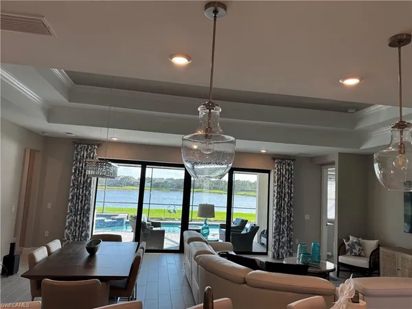 a living room with furniture and a chandelier
