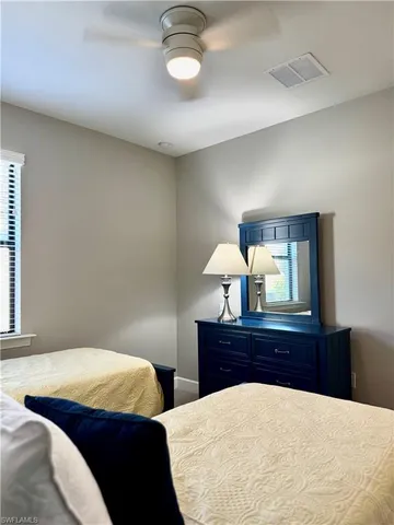 a bedroom with a bed and lamps