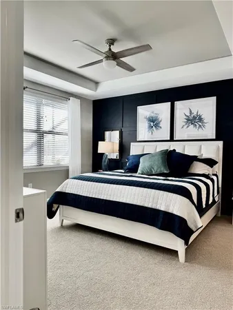 a bedroom with a bed lamp and window