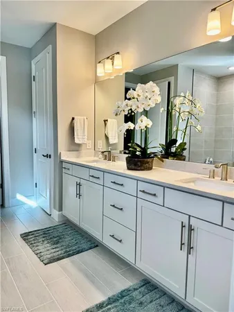 a bathroom with a double vanity sink and a mirror
