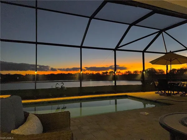 a view of a outdoor sitting area with furniture and umbrella