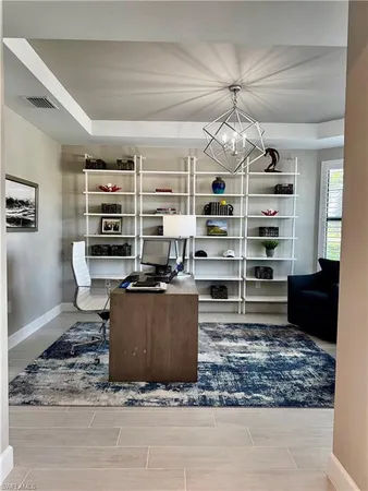 a living room with furniture and a book shelf