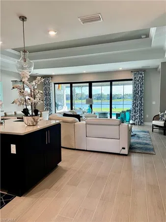 a living room with kitchen island furniture and a large window