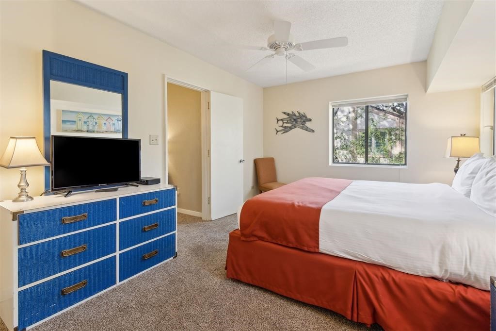 2004 Beachwood Road, Unit 2004 Fernandina Beach, FL 32034 - Photo 36 of 54 a bedroom with a bed and a flat screen tv