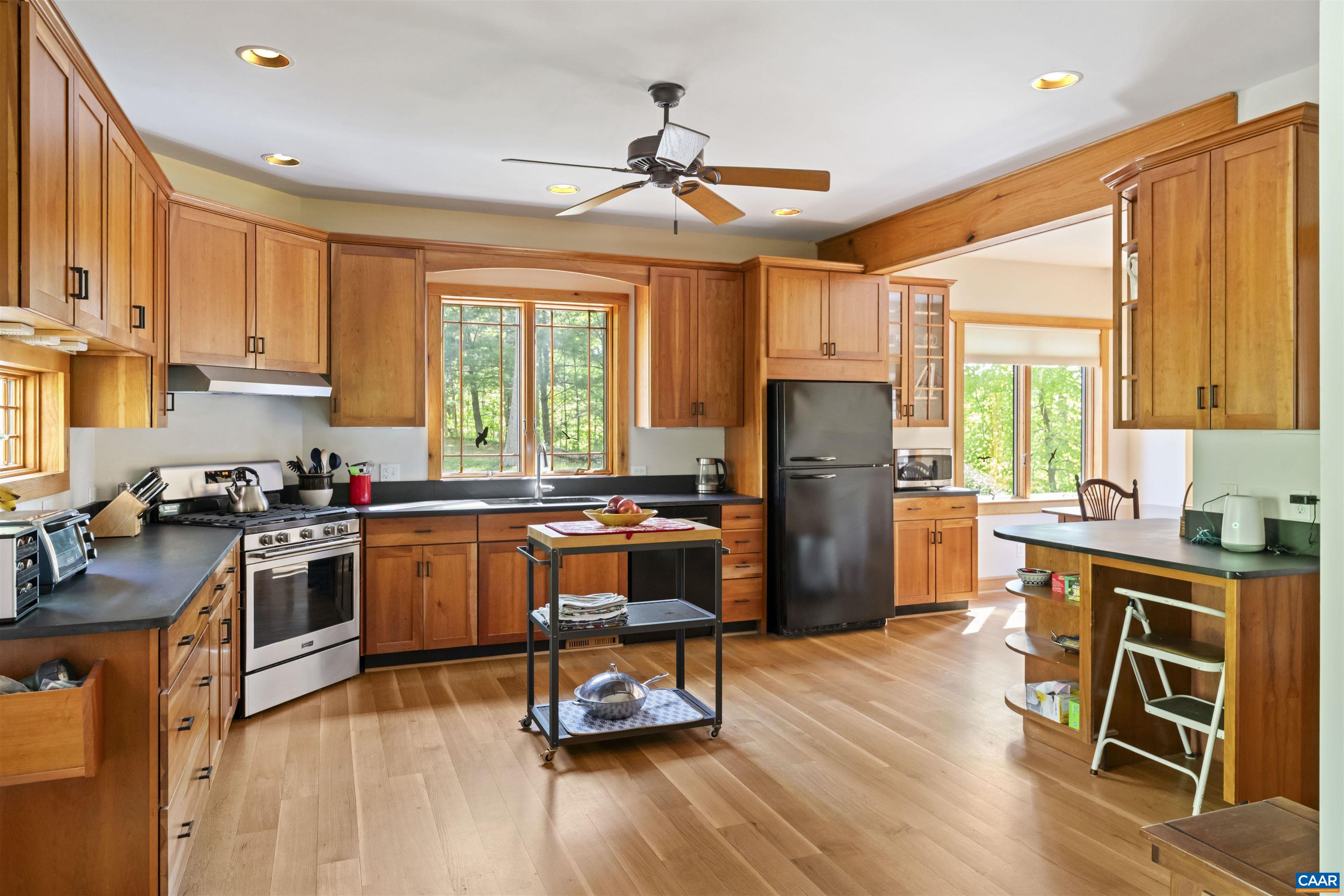7530 Damon Road Schuyler, VA 22969 - Photo 14 of 72 a kitchen with a refrigerator a stove a sink dishwasher and a dining table with wooden floor