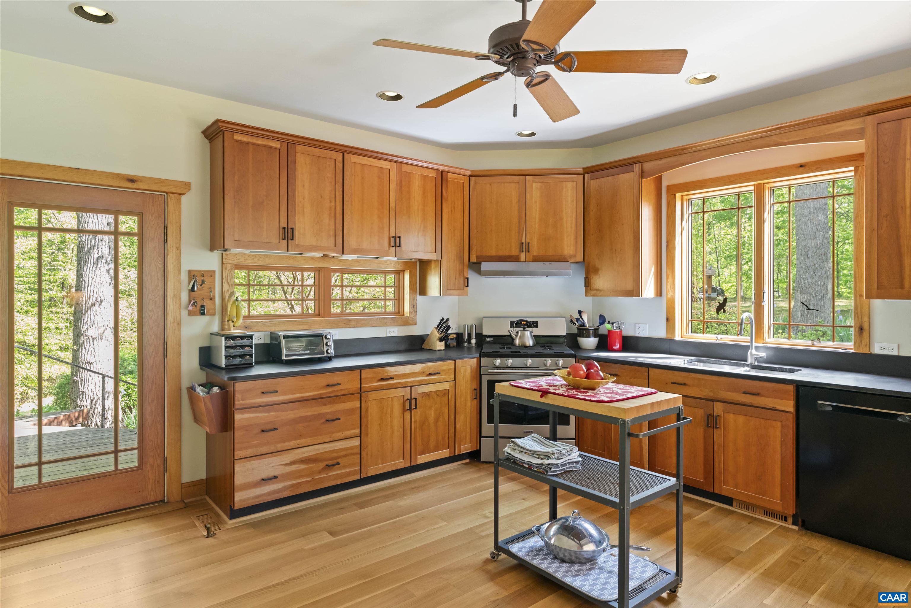 7530 Damon Road Schuyler, VA 22969 - Photo 16 of 72 a kitchen with stainless steel appliances granite countertop a stove a sink dishwasher and a chair with wooden cabinets