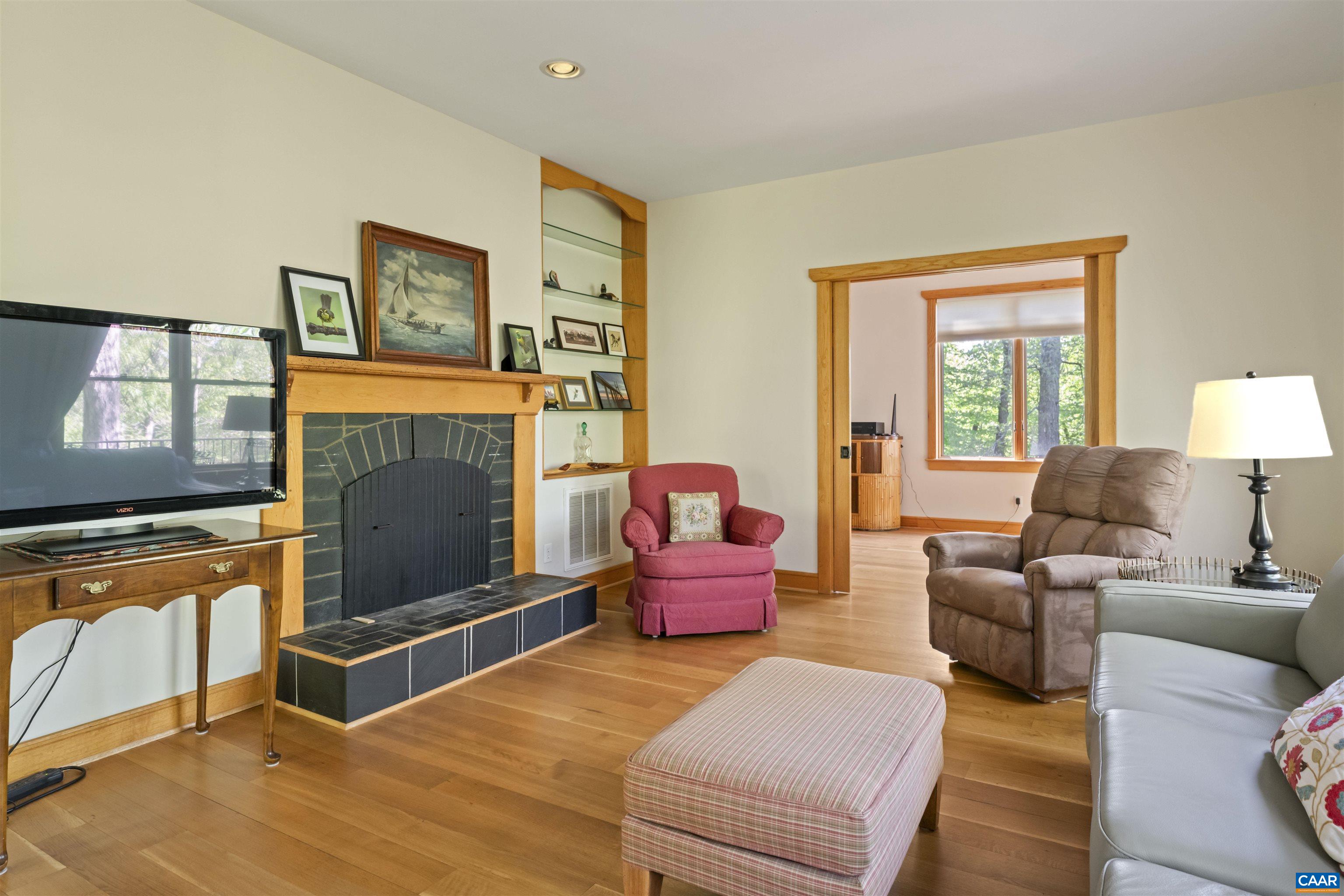 7530 Damon Road Schuyler, VA 22969 - Photo 8 of 72 a living room with furniture a flat screen tv and a fireplace
