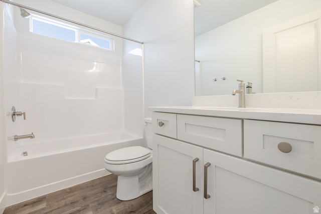 4769 Olive Avenue, Unit 411 Mapleton, UT 84664 - Photo 14 of 19 Full bath featuring vanity, bathtub / shower combination, and dark wood-style floors