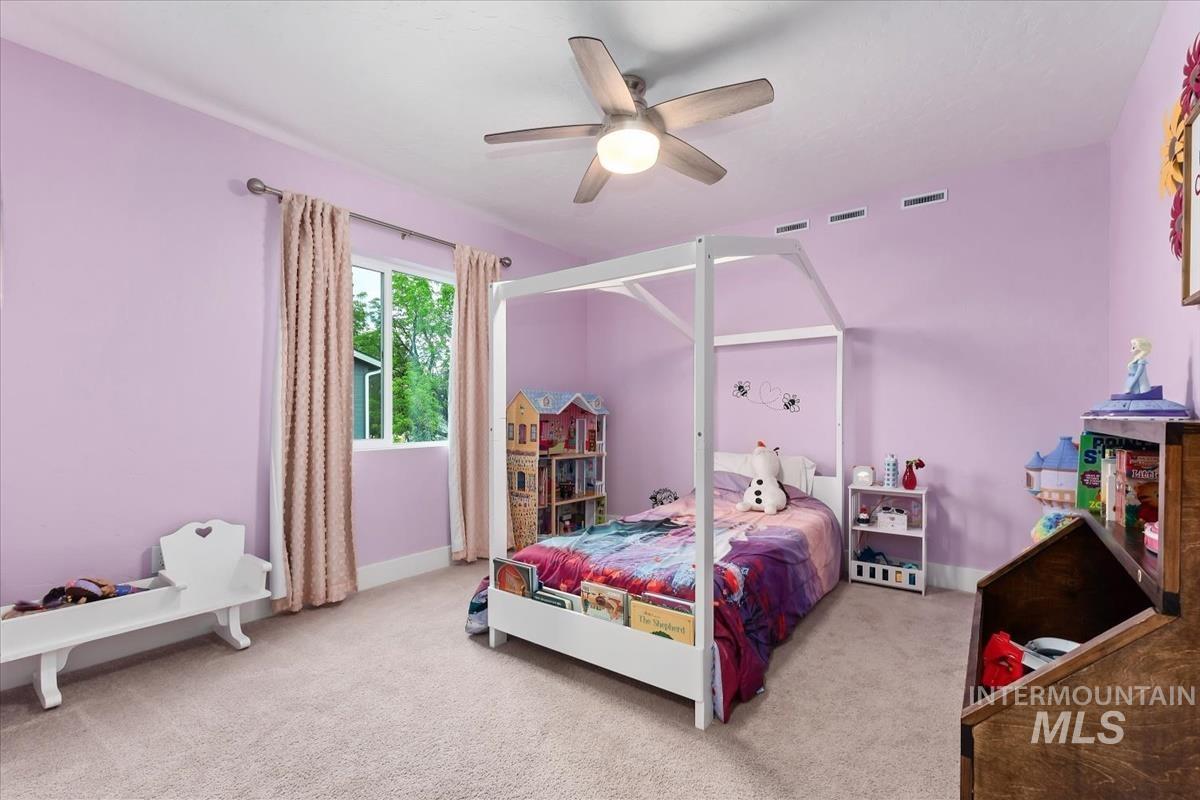 815 Knowledge Street Middleton, ID 83644 - Photo 37 of 49 Bedroom with light purple walls, a ceiling fan with integrated lighting, and carpet flooring