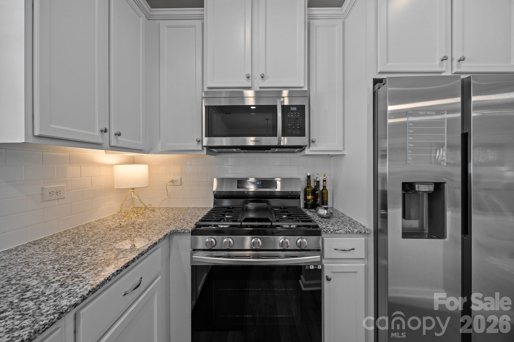 3808 Yorkshire Place Terrell, NC 28682 - Photo 15 of 36 a kitchen with stainless steel appliances granite countertop a stove and a refrigerator
