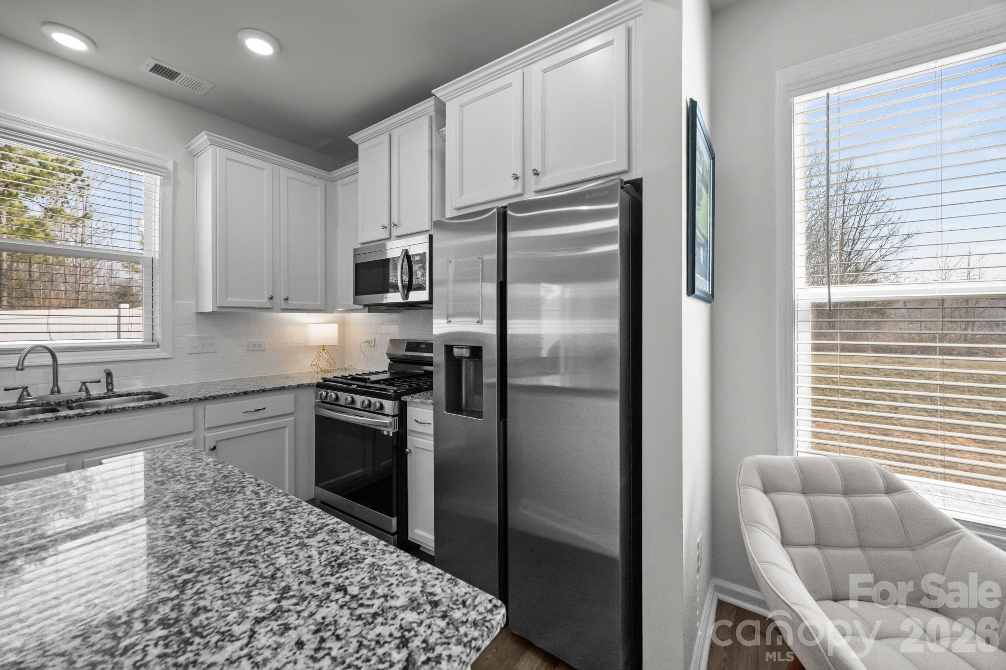 3808 Yorkshire Place Terrell, NC 28682 - Photo 16 of 36 a kitchen with granite countertop a refrigerator and a sink