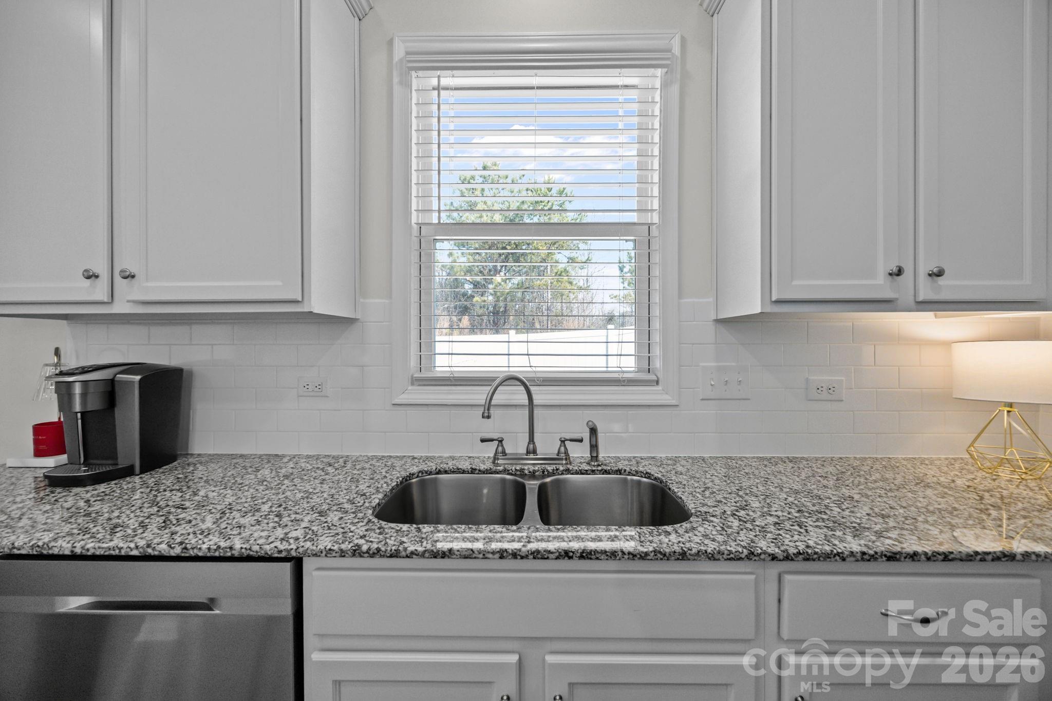 3808 Yorkshire Place Terrell, NC 28682 - Photo 17 of 36 a kitchen with granite countertop a sink window and cabinets